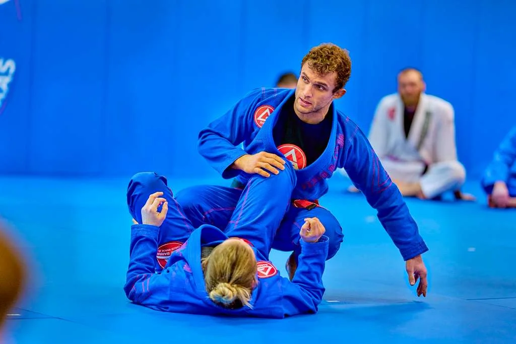 Students drilling advanced Jiu-Jitsu technique on the mat